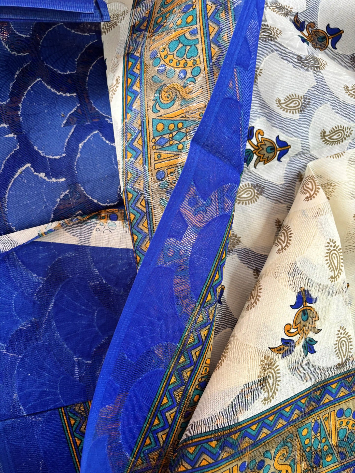 White Netted Cotton Saree with Red, Blue and Yellow Kalamkari Print, Netted Butta and Blue Border and Pallu