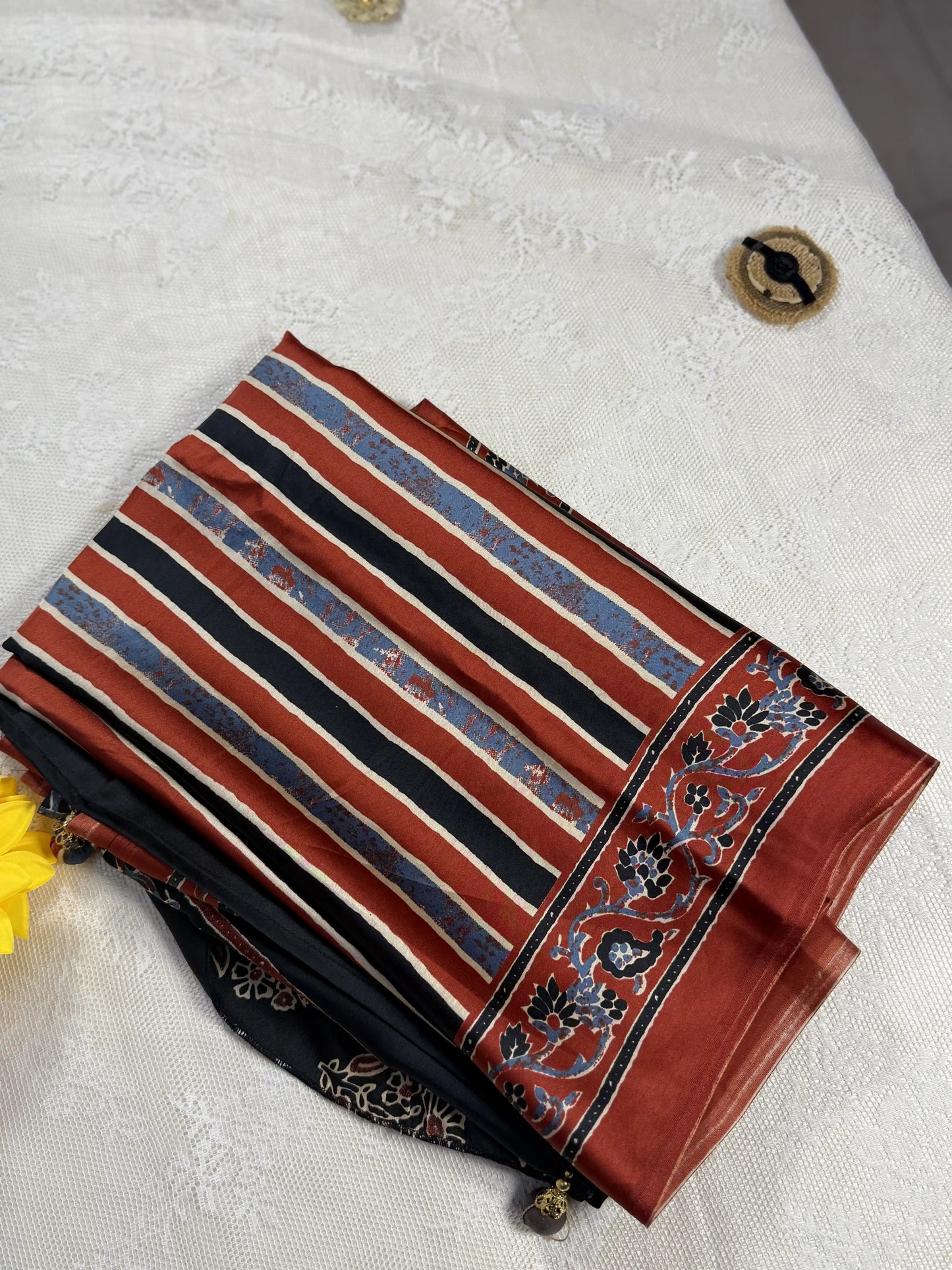 Empress Ajrakh Modal Satin Saree: Pale Gold, Red and Blue Stripped Saree with Blue and Red Marble Body with multi color ajrakh border and pallu