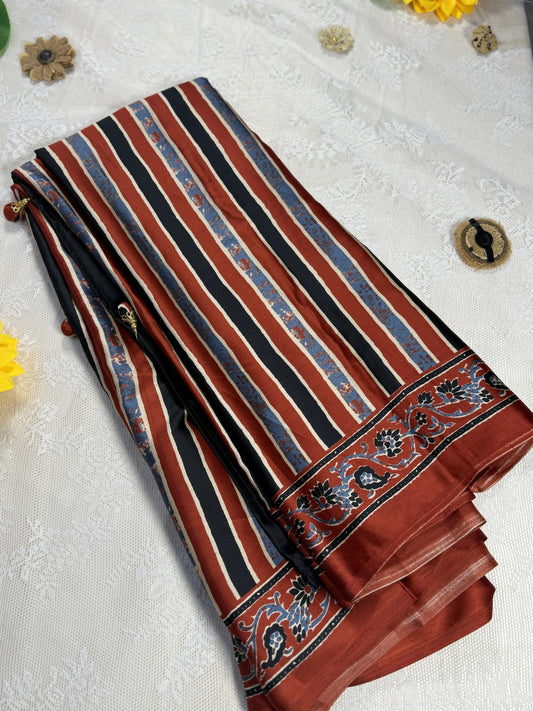 Empress Ajrakh Modal Satin Saree: Pale Gold, Red and Blue Stripped Saree with Blue and Red Marble Body with multi color ajrakh border and pallu
