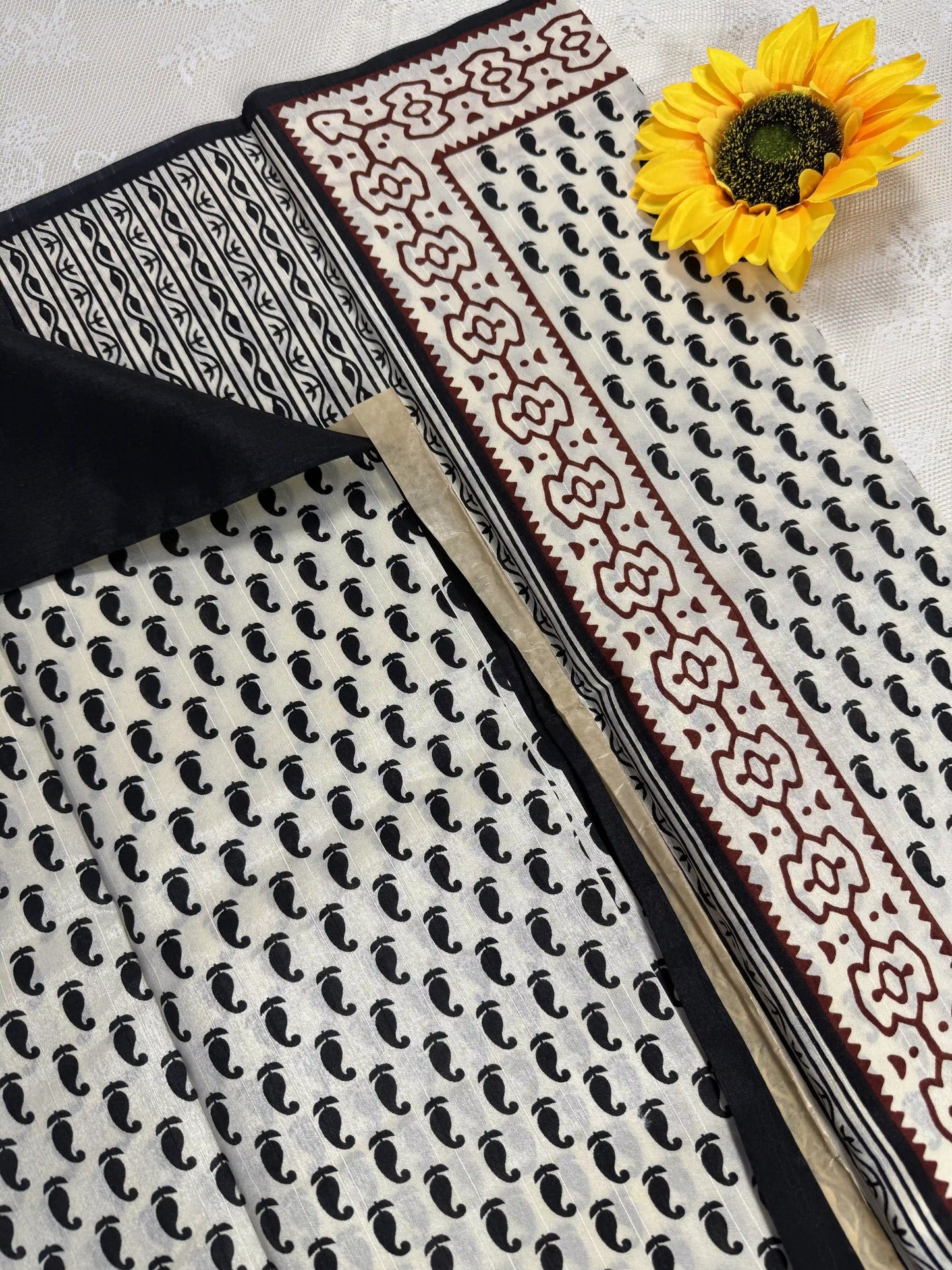 Everyday Tussar Saree: White Saree with black mango motif body and black & red floral border with white flora pallu