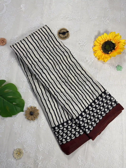 Everyday Tussar Saree: White Saree with black stripes body and black floral border with red wavy stripes pallu