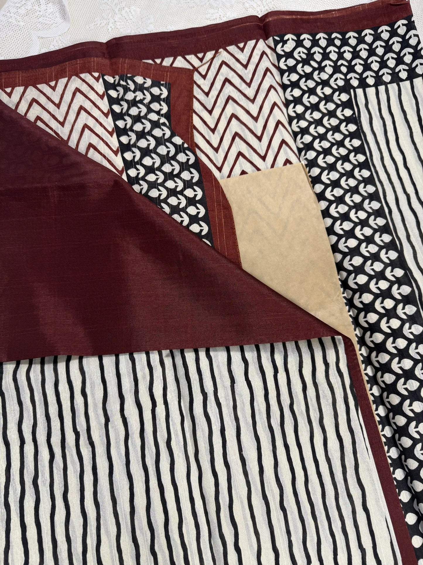 Everyday Tussar Saree: White Saree with black stripes body and black floral border with red wavy stripes pallu