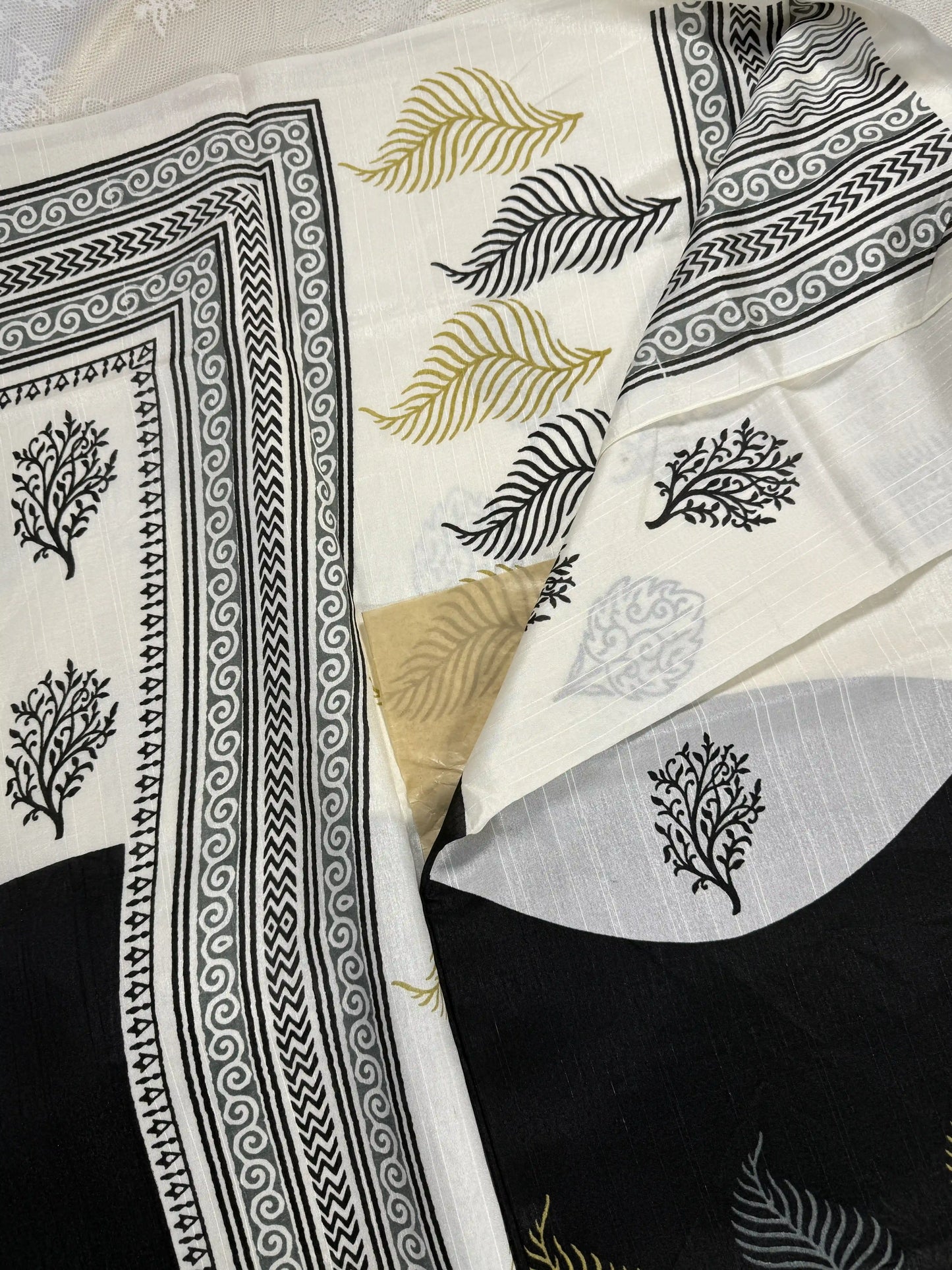 Everyday Tussar Saree: Black and white saree with gold floral motif body and white floral border with white and gold floral pallu