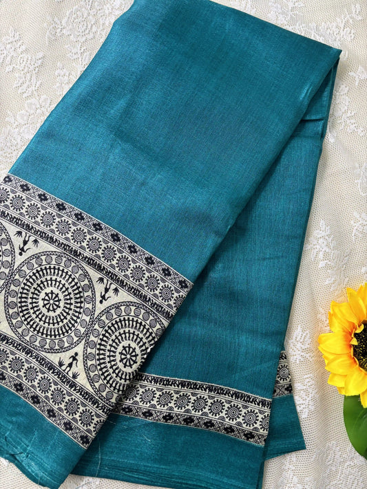 Teal blue plain body khadi silk saree with warli print border and pallu
