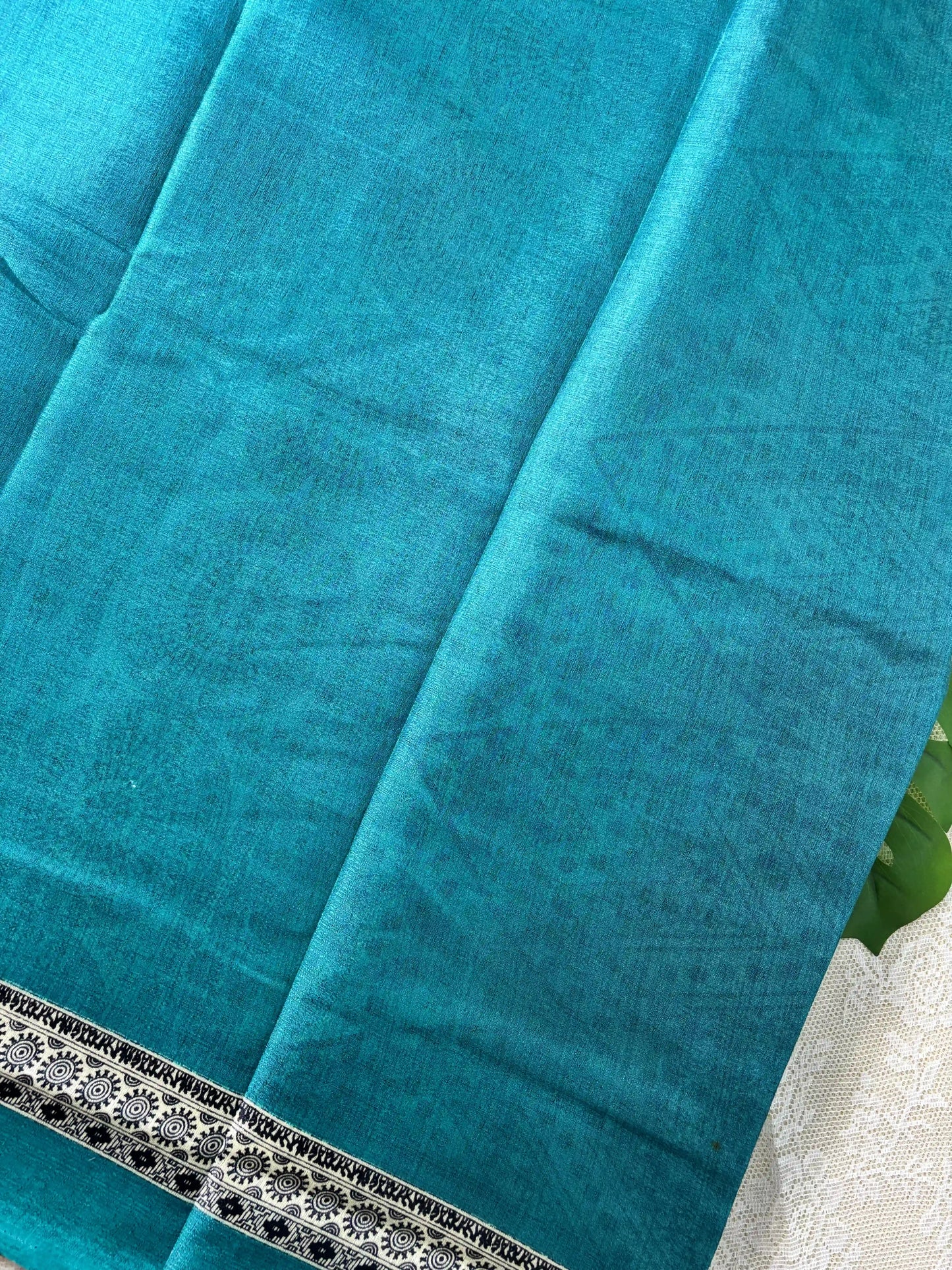 Teal blue plain body khadi silk saree with warli print border and pallu