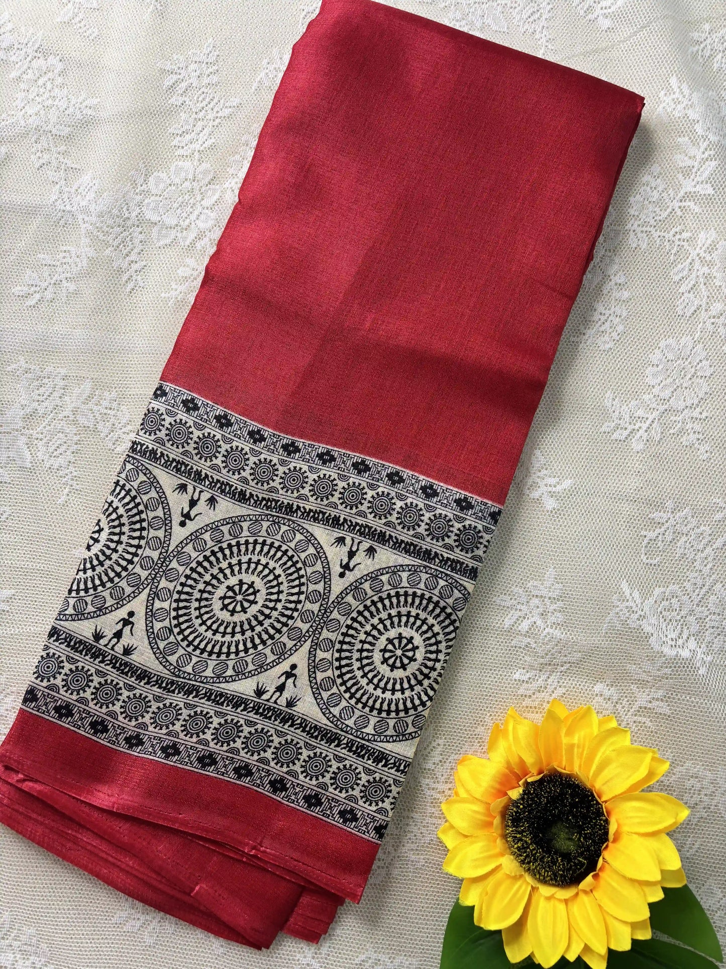 Red plain body khadi silk saree with warli print border and pallu