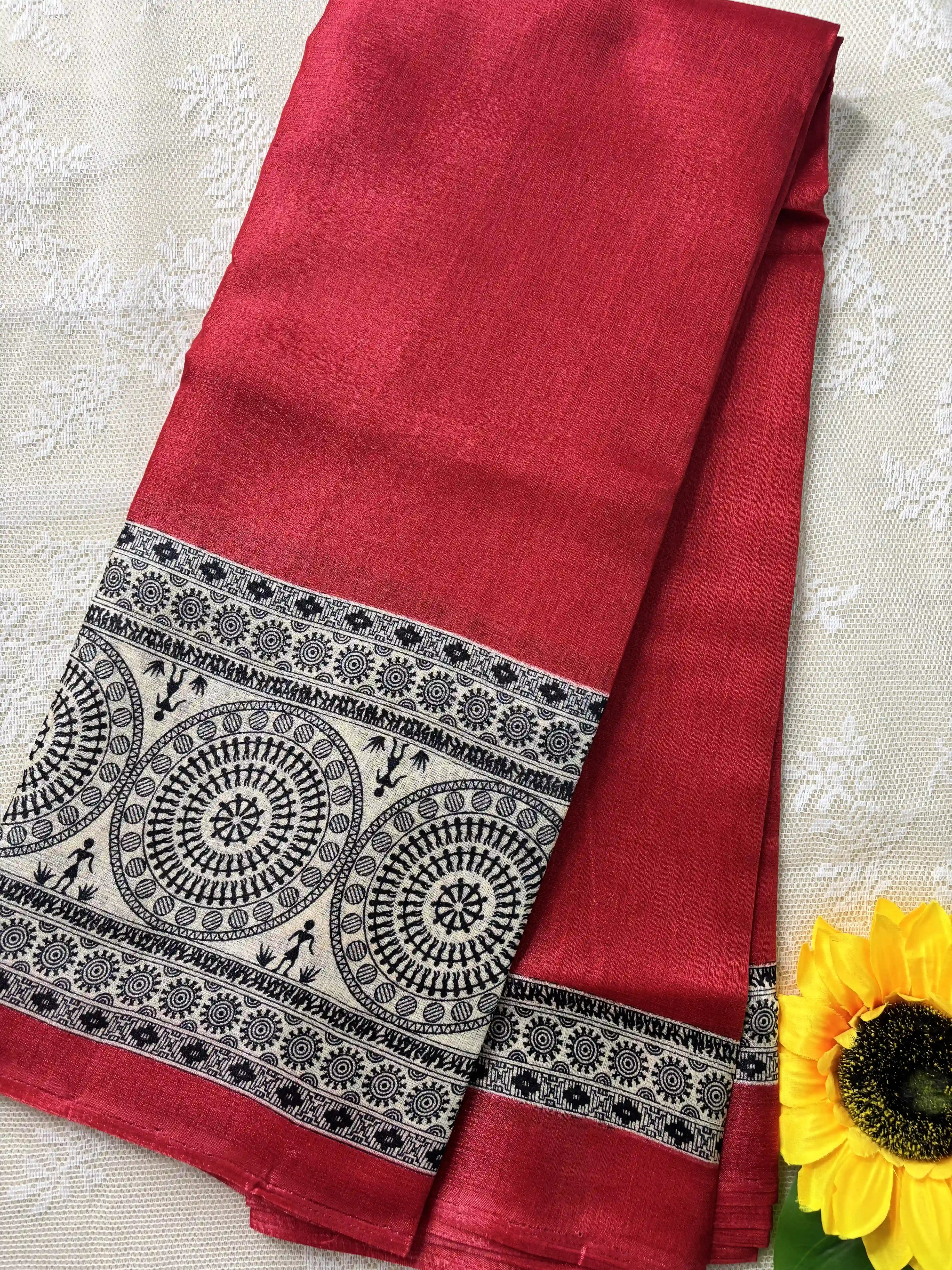 Red plain body khadi silk saree with warli print border and pallu