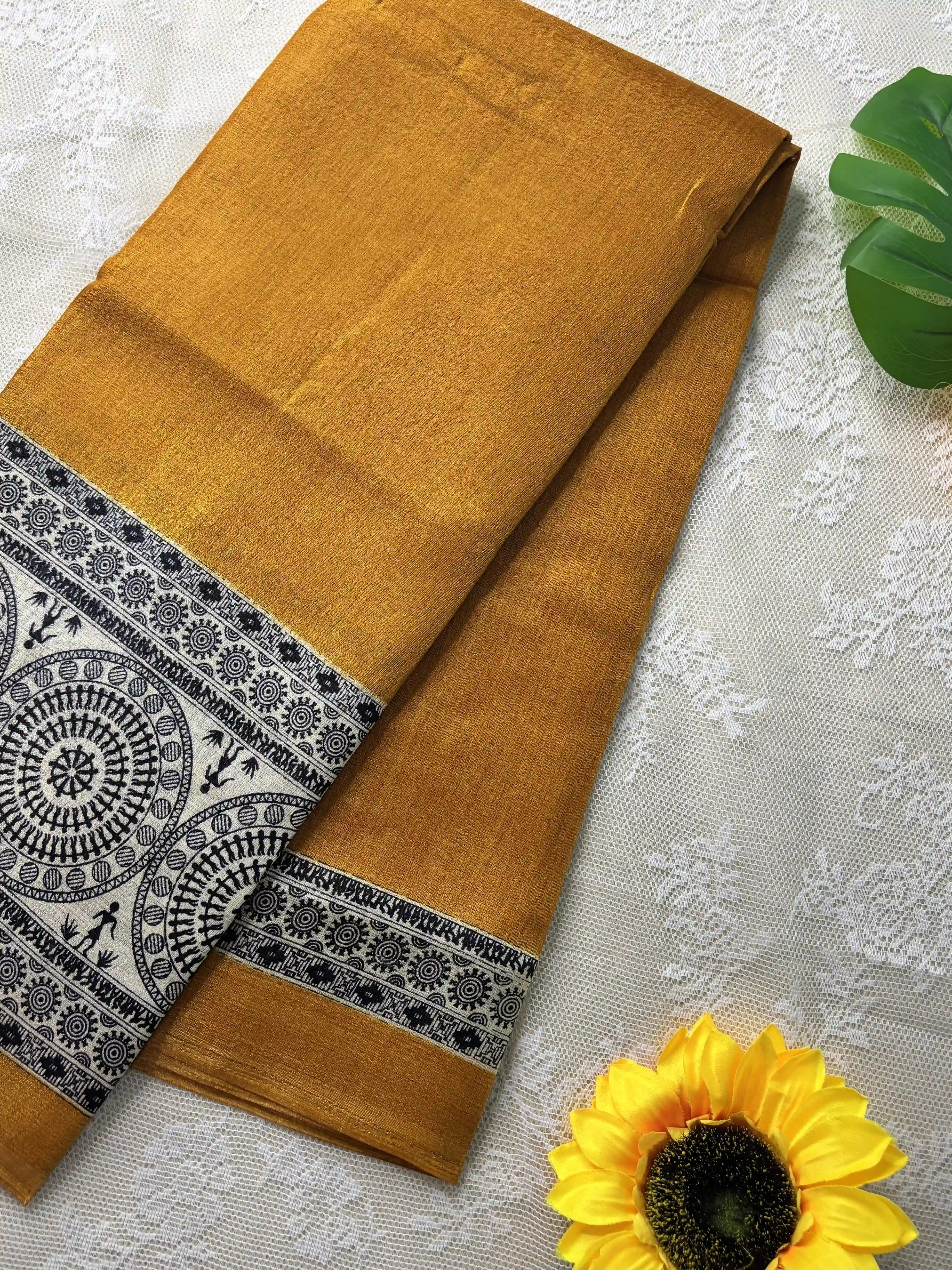 Mustard yellow plain body khadi silk saree with warli print border and pallu