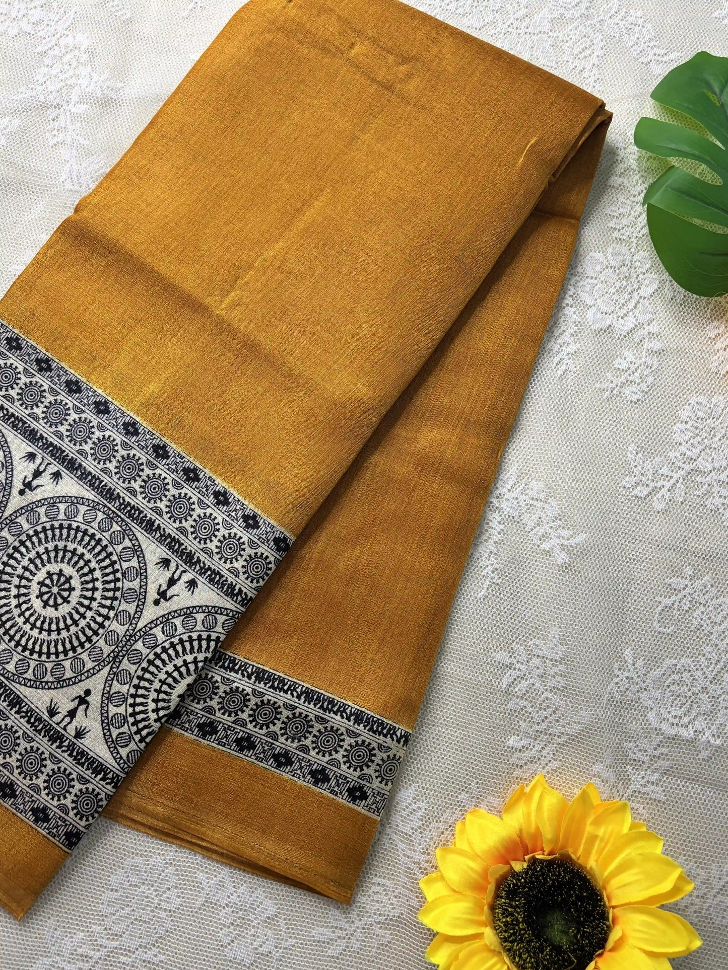 Mustard yellow plain body khadi silk saree with warli print border and pallu