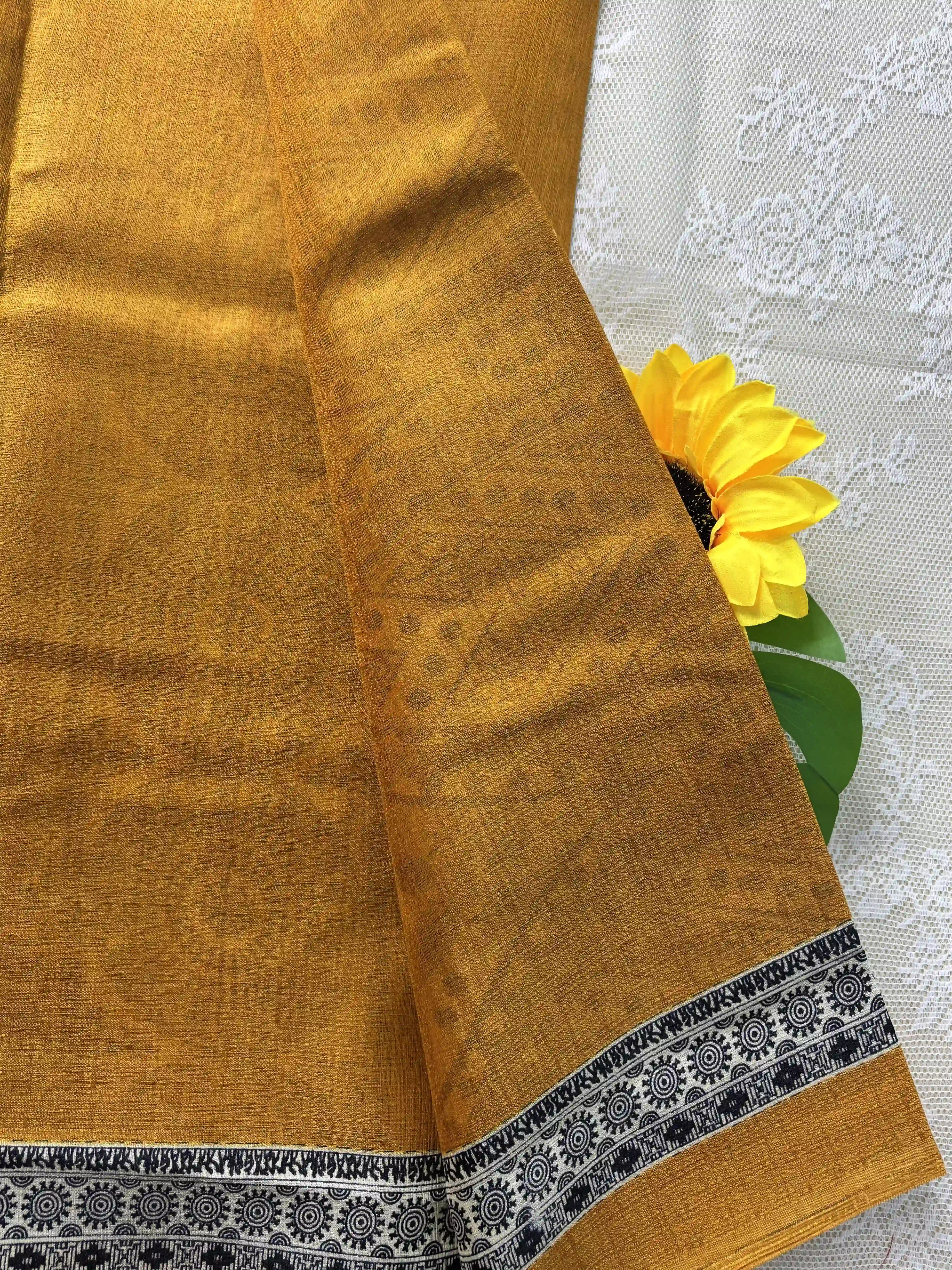 Mustard yellow plain body khadi silk saree with warli print border and pallu